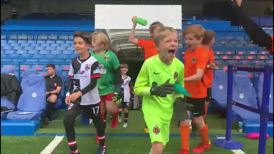 Young players walking out from a stadium tunnel at a Precision Pass event.