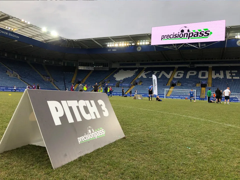 Youth footballers playing on a professional stadium pitch